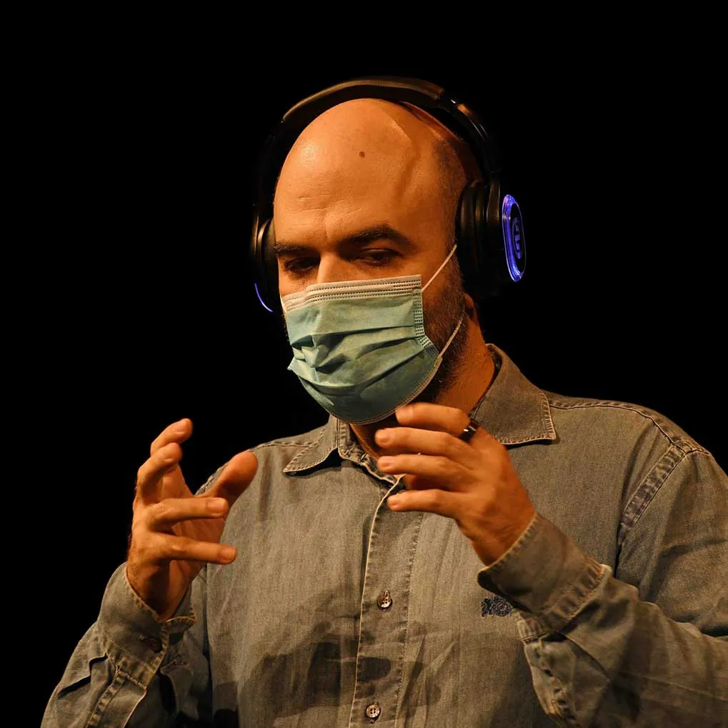 Roberto Saviano wearing wireless headphones at Piccolo Teatro Strehler - Silentsystem